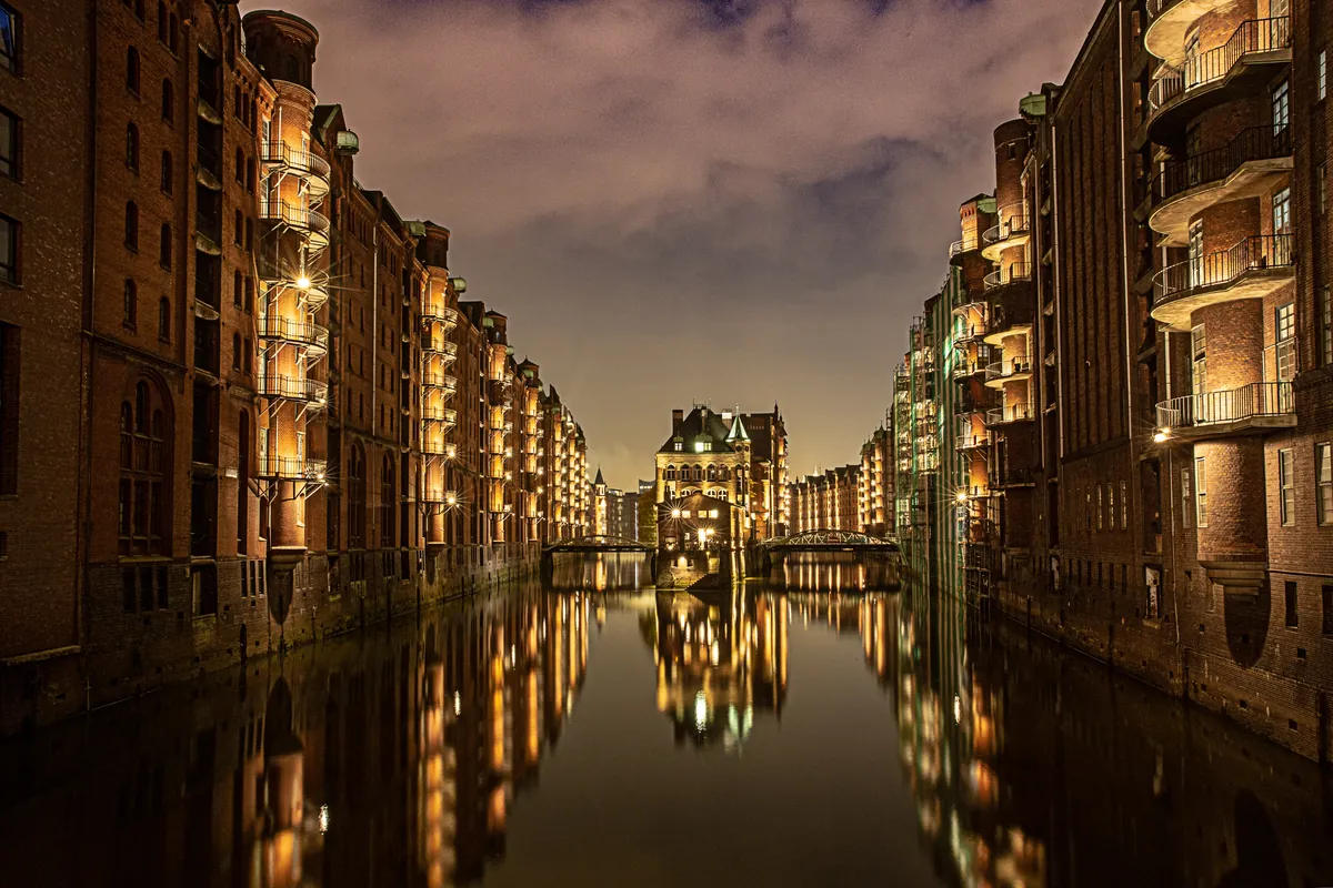 Hamburg canal and historic waterfront buildings at night