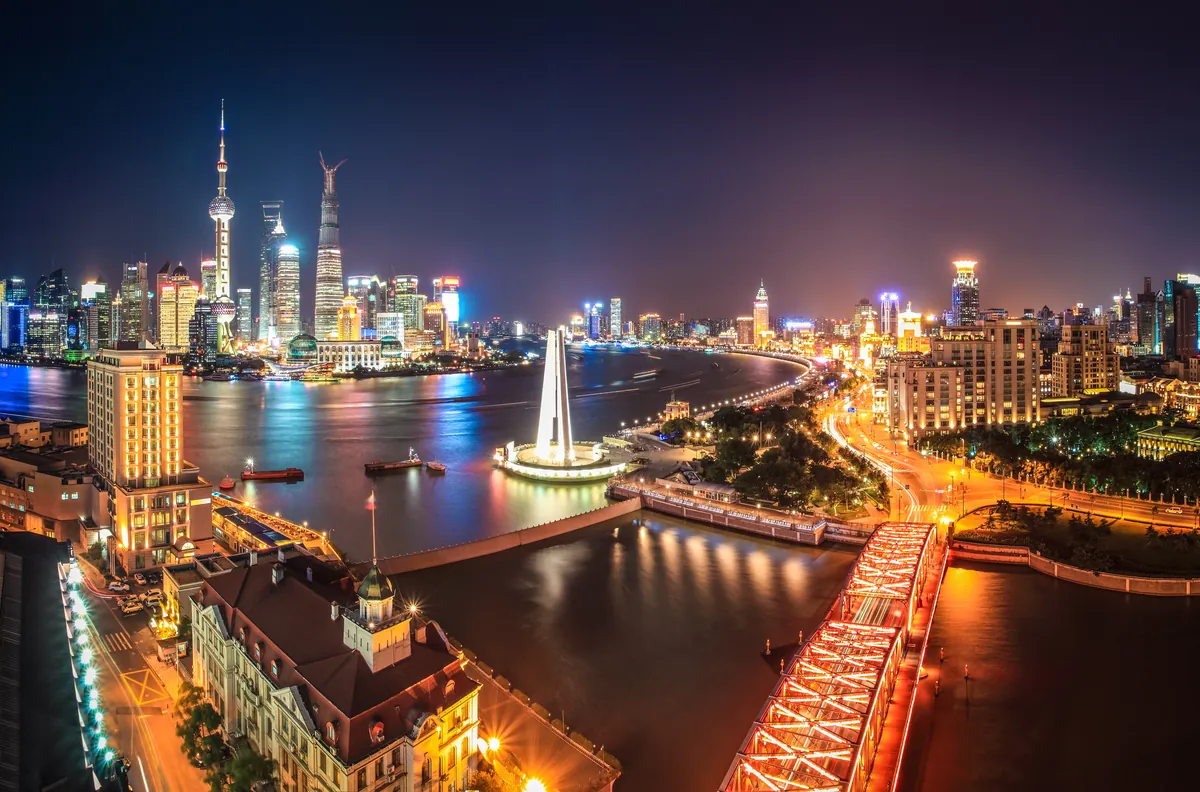 Shanghai skyline and river at night